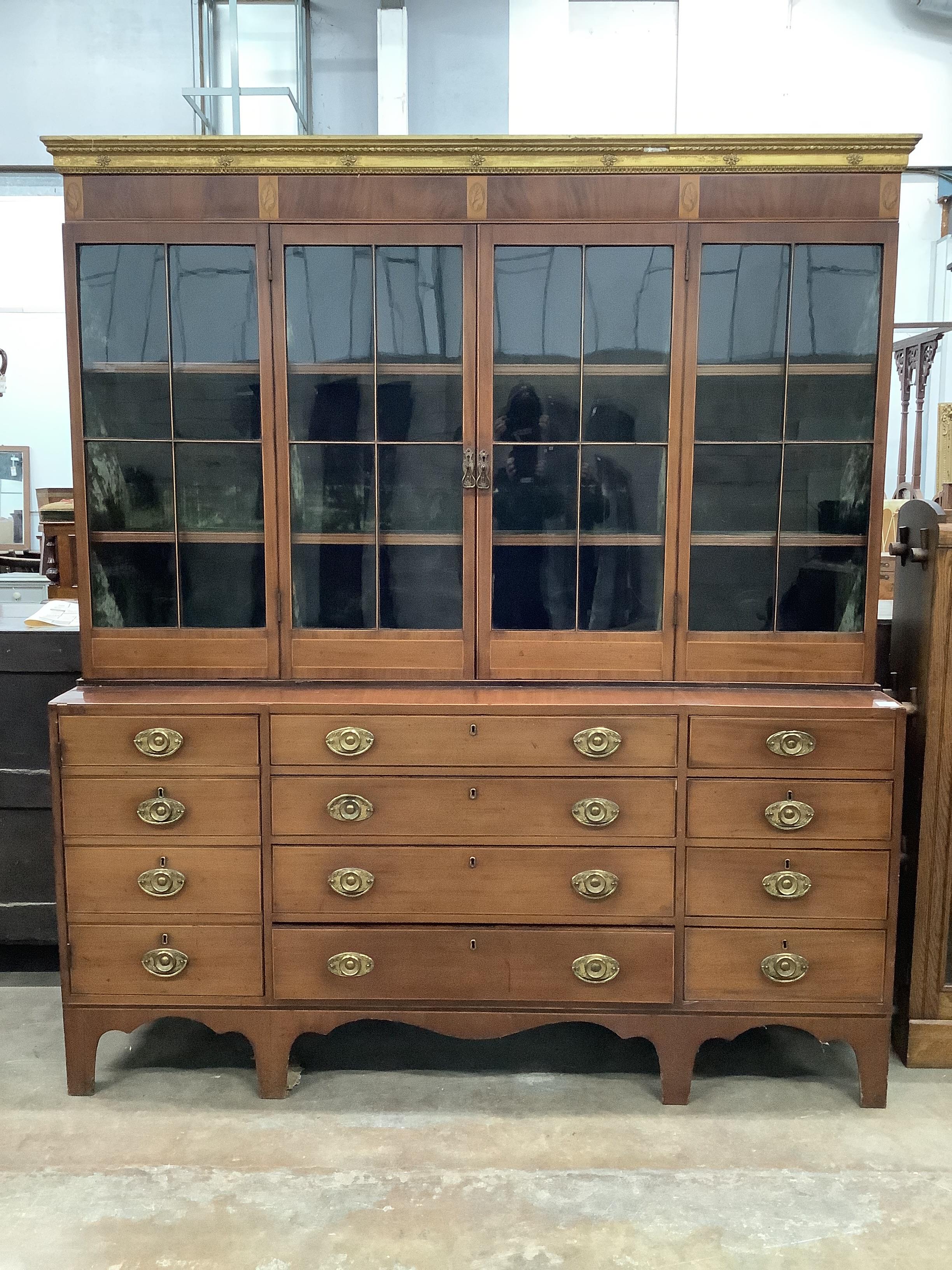 A large George IV and later inlaid mahogany library bookcase with parcel gilt pediment, width 182cm, depth 44cm, height 204cm